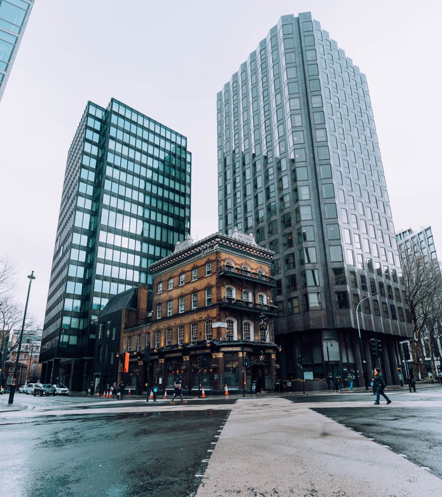 Victorian building between modern office towers